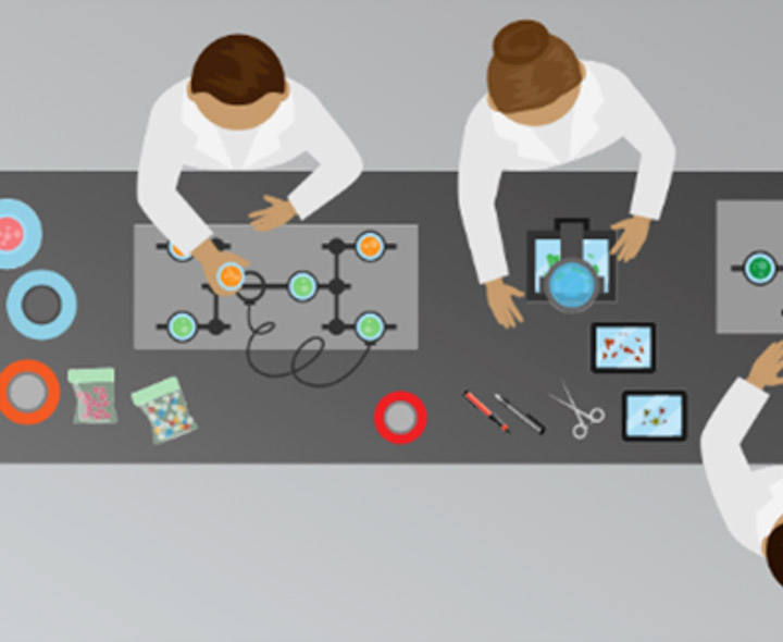 A graphic of three people working around a rectangular table doing sciency stuff.