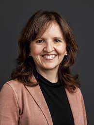 A formal portrait photo of a woman with brown, shoulder-length hair