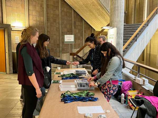 ALIVE Symposium participants checking in at the registration desk